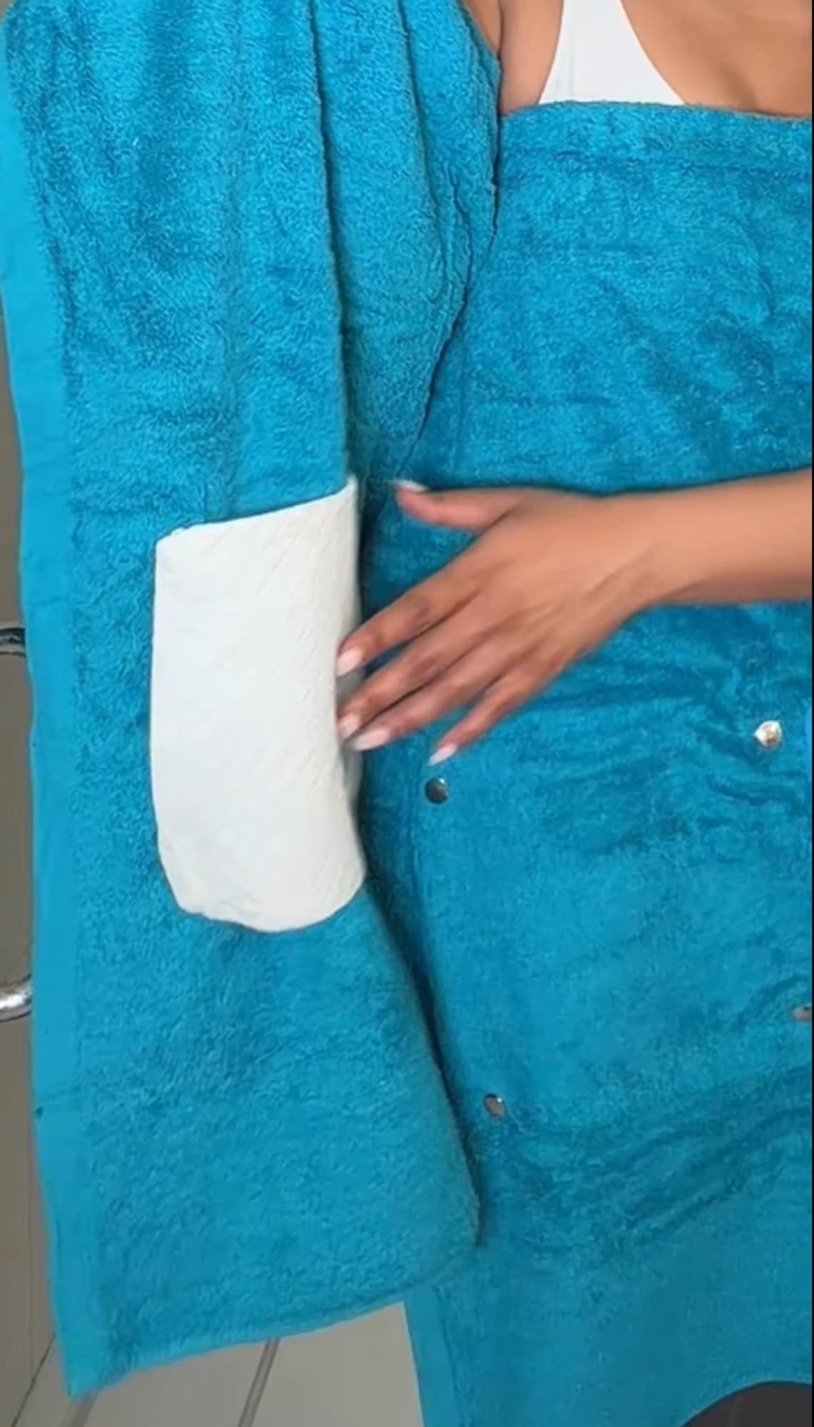 Closeup of the disposable pocket snapped onto the Smart Towel while worn.