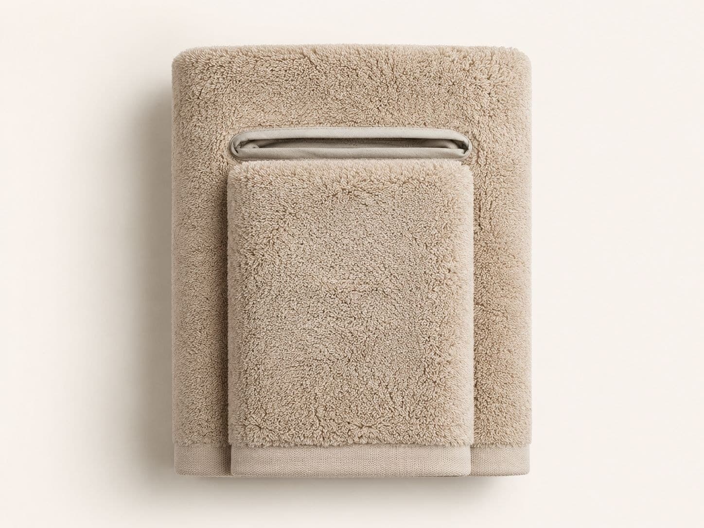 The Deyshine Smart Towel in Oatmeal, folded with its snap-on pocket.